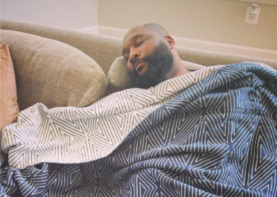 black man sleeping with blanket